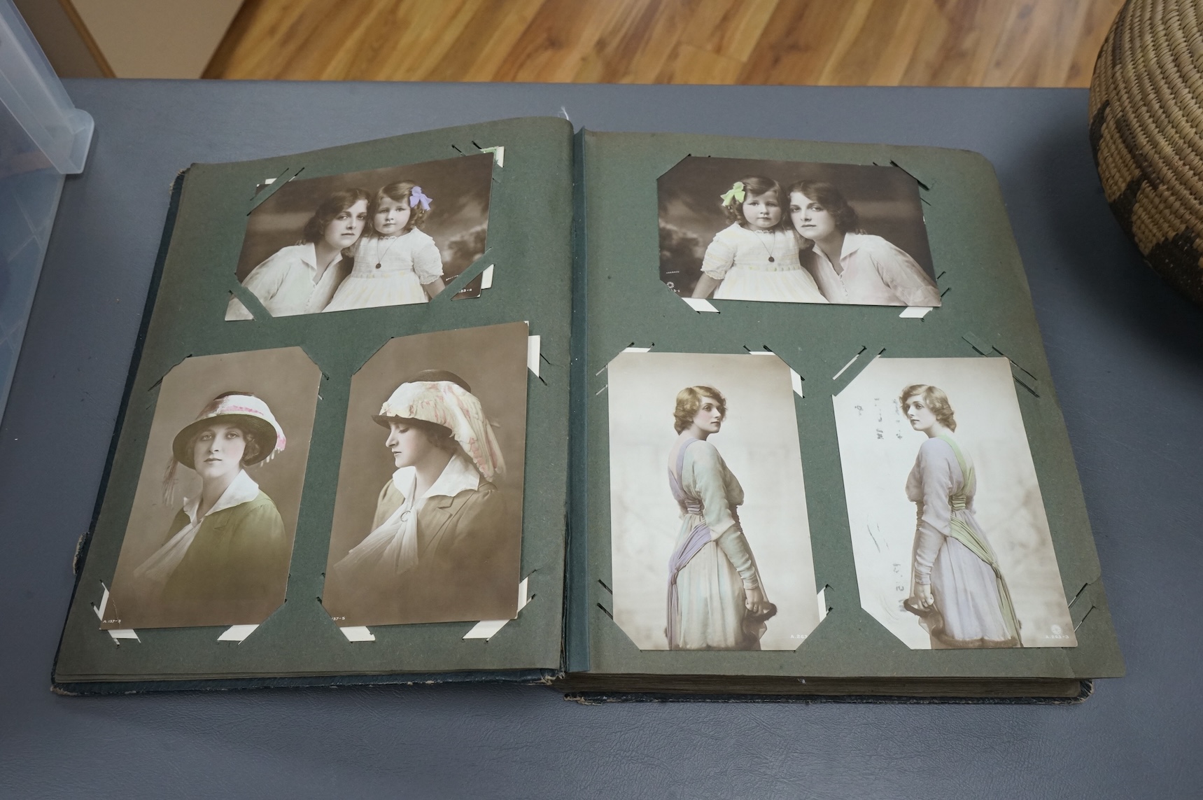 A postcard album containing early 20th century postcards, Gladys Cooper, comics, some photographs